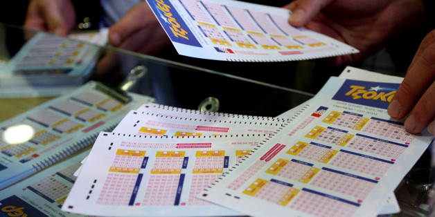 People collect Joker lottery tickets in a lottery store in Thessaloniki on April 15, 2010. Greeks rush to test their luck as the Joker lottery game gives a jackpot of 19 milion euros. Greece suffered a new setback on April 14 when its borrowing rate shot up again to above seven percent. AFP PHOTO /Sakis Mitrolidis (Photo credit should read SAKIS MITROLIDIS/AFP/Getty Images)
