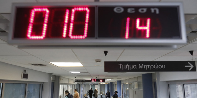 Greek taxpayers are seen inside Pallini's tax office in Pallini suburb, east of Athens February 15, 2013. Greece is pinning its hopes of boosting revenue from an antiquated tax system beset by massive evasion on Harry Theoharis, a boyish-looking 42-year-old who describes himself as an "I.T. monkey". REUTERS/John Kolesidis (GREECE - Tags: POLITICS BUSINESS)