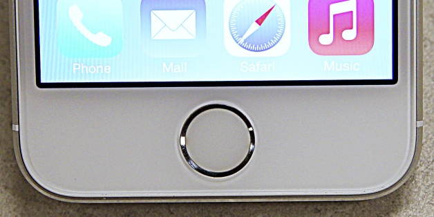 A close up view of the fingerprint scanner on the new Apple iPhone 5S is seen at a Verizon store in Orem, Utah September 19, 2013. The iPhone 5C, which comes in blue, green, pink, yellow and white, starts in the U.S. at $99 with a contract and the pricier "5S" begins at $199 with a contract. Both models go on sale in several countries on September 20. REUTERS/George Frey (UNITED STATES - Tags: BUSINESS TELECOMS)