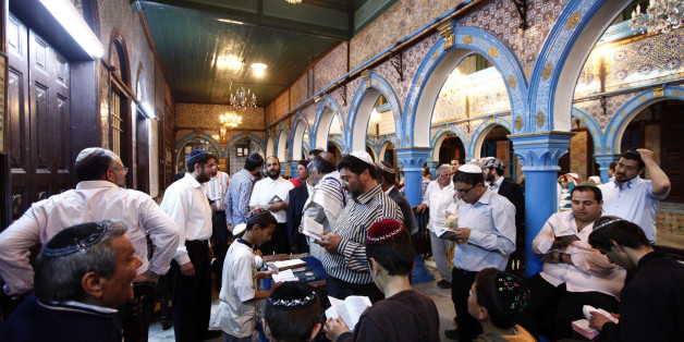 Jewish men pray inside the blue-tiled El Ghriba synagogue on the Tunisian island of Djerba following a wedding ceremony May 10, 2012. Security concerns and threats from some Salafi Islamists kept thousands of Jewish pilgrims away from an annual celebration on the Tunisian island of Djerba this week, with no more than 500 pilgrims attending - an event that used to attract thousands of visitors. Numbers have plummeted since the overthrow of authoritarian secular leader Zine al-Abidine Ben Ali in a