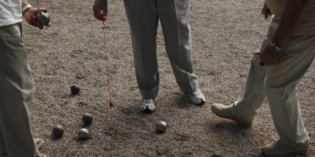 Low section view of three people playing petanque, Alpes-Maritimes, France