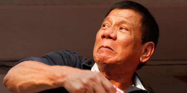 Presidential candidate Rodrigo "Digong" Duterte throws election souvenir shirts to his supporters during election campaigning in Malabon, Metro Manila in the Philippines April 27, 2016. REUTERS/Erik De Castro