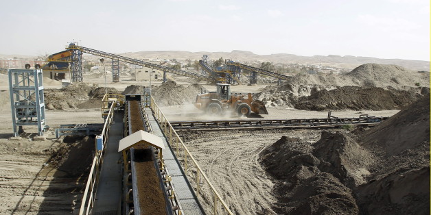 A bulldozer works at a phosphate mines in Metlaoui, Tunisia April 6, 2012. Phosphate production at Tunisia's Metaloui partially resumed on Sunday and shipments restarted after protesters agreed to temporarily end their sit-in over job demands, the company said. Metaloui, which produces around 60 percent of Tunisia's phosphate output, has been closed by weeks of protests by local youths demanding employment and economic opportunities. Other plants in the south of the country have also been affect