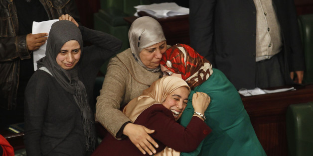Members of the Tunisian parliament celebrate after approving the country's new constitution in the assembly building in Tunis January 26, 2014. Tunisia's national assembly approved the country's new constitution on Sunday in one of the final steps to full democracy three years after protests erupted into an uprising that toppled autocrat Zine el-Abidine Ben Ali. REUTERS/Zoubeir Souissi (TUNISIA - Tags: POLITICS TPX IMAGES OF THE DAY)