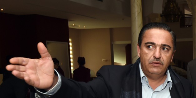 Tunisian businessman, Chafik Jarraya (L), greets Awad Mohammed Abdul-Sadiq (C), the first deputy head of the Tripoli-based General National Congress (GNC), and Ibrahim Fethi Amish, from Libyas internationally recognised House of Representatives, ahead of a ceremony of signing documents on reaching an agreement on ending the political deadlock in Libya, in the Tunisian town of Gammarth, on the outskirts of Tunis, on December 6, 2015. The warring Libyan factions meeting in Tunisia said they had reached an agreement to be approved by rival parliaments on ending the political deadlock that has plagued the country since Moamer Kadhafi's overthrow. AFP PHOTO / FETHI BELAID / AFP / FETHI BELAID (Photo credit should read FETHI BELAID/AFP/Getty Images)