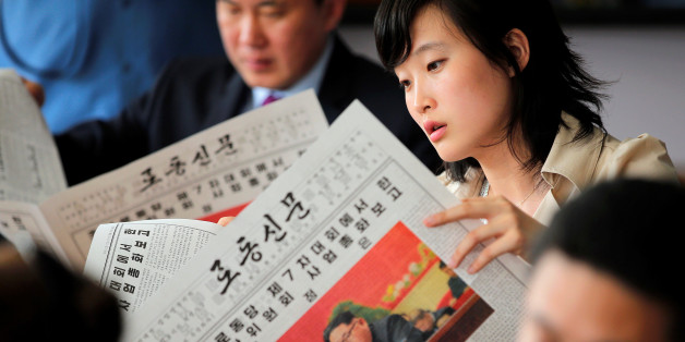 Foreign reporters and their government guides follow, in newspapers and broadcasted on television, the address by North Korean leader Kim Jong Un to the Workers' Party of Korea (WPK) congress, at a hotel in central Pyongyang, North Korea May 8, 2016. REUTERS/Damir Sagolj