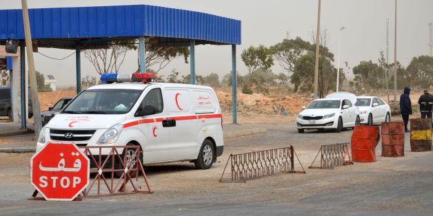 Tunisian security forces check vehicles near the Tunisian customs post at the Ras Jedir border crossing with Libya, south of the town of Ben Guerdane, on March 22, 2016 after it was reopened after a two-week closure in response to a deadly jihadist attack on a town near the frontier.
Both the Ras Jedir crossing on the Mediterranean coast and the Dehiba crossing in the mountainous desert interior reopened at 0600 GMT, ministry spokesman Yasser Mesbah said.Tunisia closed the two crossings on March 7 when dozens of heavily armed jihadists who had slipped across the border from Libya launched coordinated attacks on police and army posts in the town of Ben Guerdane, north of Ras Jedir.
/ AFP / FATHI NASRI (Photo credit should read FATHI NASRI/AFP/Getty Images)