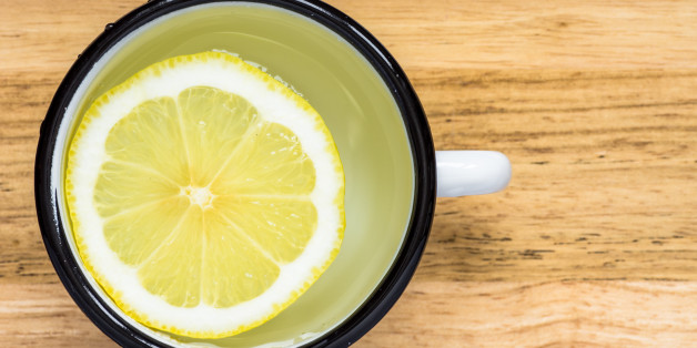 Water with lemon in a steel mug top view