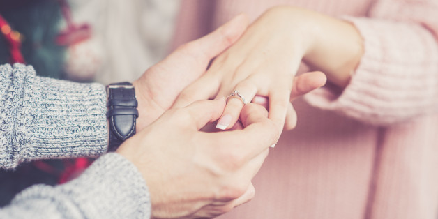 Close up shot of young man proposing on New Year with a beautiful ring