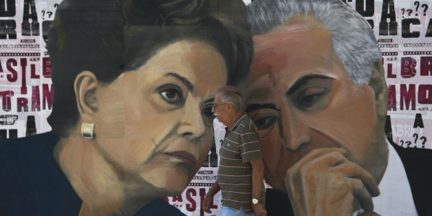 A man walks past a mural depicting Brazilian President Dilma Rousseff (L) and Vice-President Michel Temer at Paulista Avenue in Sao Paulo, Brazil on April 19, 2016.
Brazil woke Monday to deep political crisis after lawmakers authorized impeachment proceedings against President Dilma Rousseff, sparking claims that democracy was under threat in Latin America's biggest country. / AFP / NELSON ALMEIDA (Photo credit should read NELSON ALMEIDA/AFP/Getty Images)