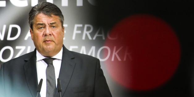 In this photo taken with a control light of a television camera in front, German Social Democratic Party, SPD, chairman and Germany's Vice Chancellor Sigmar Gabriel delivers a speech at a party congress in Berlin, Germany, Monday, May 9, 2016. (AP Photo/Markus Schreiber)