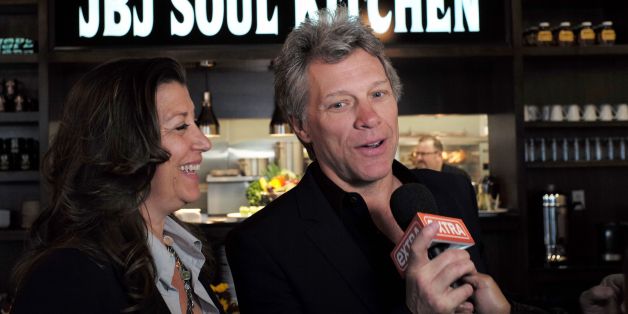 US signer Jon Bon Jovi and his wife Dorothea speak to the media after opening the BEAT (Bringing Everyone All Together) center in Toms River, New Jersey, on May 10, 2016.
The Food Bank of Monmouth and Ocean Counties, Jon Bon Jovi Soul Foundation and Peoples Pantry announced the opening of BEAT, a place where families and individuals can access food, job training and resources to help end the cyclical causes of hunger in Ocean county. / AFP / Jewel SAMAD (Photo credit should read JEWEL SAMAD/AFP/Getty Images)