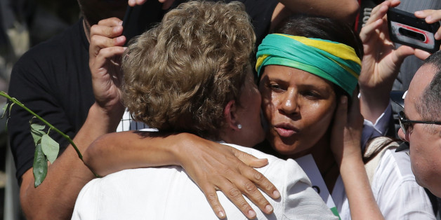 A supporter hugs Brazilian President Dilma Rousseff as she leaves Planalto presidential palace in Brasilia, Brazil, Thursday, May 12, 2016. Speaking hours after the Senate voted to suspend her on Thursday, Rousseff blasted the impeachment process against her as "fraudulent" and promised to fight what she characterized as an injustice more painful than the torture she endured under a past military dictatorship. (AP Photo/Eraldo Peres)