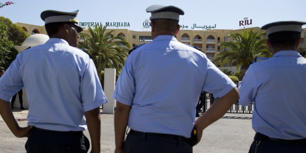 Tunisian policemen stand guard at the Riu Imperial Marhaba Hotel in Port el Kantaoui, on the outskirts of Sousse south of the capital Tunis, on June 29, 2015 where a deadly attack took place the previous week. Tunisia said it had made its first arrests after a beach massacre that killed 38 people, as European officials paid tribute to victims of the country's worst jihadist attack. AFP PHOTO / KENZO TRIBOUILLARD (Photo credit should read KENZO TRIBOUILLARD/AFP/Getty Images)