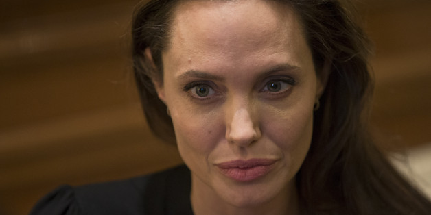 U.S. actress Angelina Jolie listens Greek Prime Minister Alexis Tsipras during their meeting in Athens, on Wednesday, March 16, 2016. American actress and U.N. refugee agency envoy Angelina Jolie is in Athens on Tuesday to meet political leaders and visit overcrowded shelters, as the number of refugees and migrants nears 44,000. (AP Photo/Petros Giannakouris)