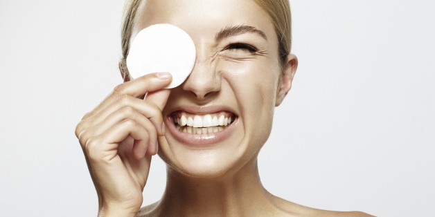 Laughing woman removing make-up