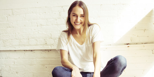 Young woman sitting on floor