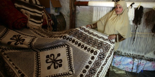 Nacera Benchenouf, 45, displays a carpet she made at her house in Babar village in the eastern city of Khenchela May 19, 2009. Babar carpets, which takes up to 3 months to make, are the most expensive carpets in Algeria. The patterns on these carpets represent the identity of the Shawia culture. To preserve this traditional tapestry craft, a museum for showcasing these carpets will soon be built at Babar village. REUTERS/Zohra Bensemra (ALGERIA SOCIETY)