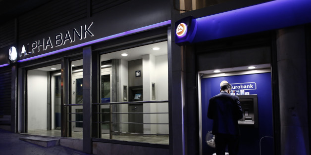 A customer uses an automated teller machines (ATM) operated by Eurobank Ergasias SA beside an Alpha Bank AE bank branch in Athens, Greece, on Tuesday, Nov. 3, 2015. Greece's four biggest banks may need as little as 1.2 billion euros ($1.3 billion) of new private funds to meet their expected contributions toward filling a capital shortfall, if they succeed in raising 3.2 billion euros through debt swaps. Photographer: Kostas Tsironis/Bloomberg via Getty Images