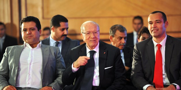Tunisian former prime minister and presidential candidate, Beji Caid Essebsi looks on with the leader of the Free Patriotic Union (UPL) and former presidential candidate Slim Riahi (L), and leader of Afek Tounes Party Yassine Brahim (R) during Essebsi's presentation of his presidential program in Tunis on December 15, 2014. In the first round of polling last month Essebsi took 39.46 percent of votes cast among 27 candidates and Tunisia's incumbent President Moncef Marzouki 33.43 percent. AFP PHOTO/ FETHI BELAID (Photo credit should read FETHI BELAID/AFP/Getty Images)