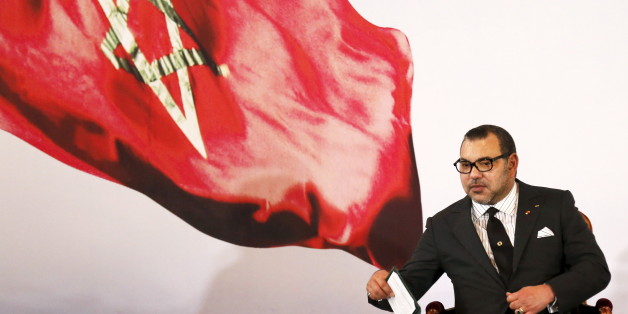 Morocco's King Mohammed VI holds a book during a visit, at the presidential palace in Abidjan June 2, 2015. REUTERS/Thierry Gouegnon