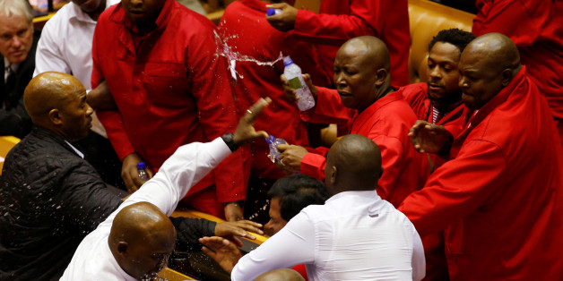 Party leader Julius Malema and members of his Economic Freedom Fighters (EFF) clash with Parliamentary security as they are evicted from the chamber in Cape Town, South Africa, May 17, 2016. REUTERS/Mike Hutchings