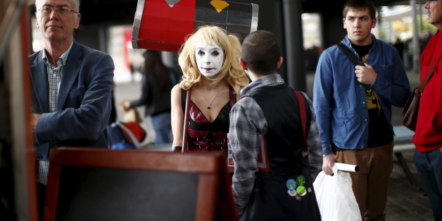 A Paris Comic Con attendee waits as "Harley Quinn" during the first day of the event in Paris, France, October 23, 2015. The event draws thousands of costumed fans, panels of pop culture luminaries and features a sprawling floor of vendors at the Grande halle de la Villette in Paris. REUTERS/Benoit Tessier