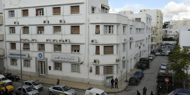 Soldiers guard on November 25, 2011 the headquarters of the Gafsa Phosphates Company (CPG) in Tunis, whose recruitment policy led to violence particularly in the towns of Oum Larayes and Mhdilla. Barbed wire was placed around the headquarters of the GPC and its parent, the Tunisian Chemical Group, located on the same street. AFP PHOTO / FETHI BELAID (Photo credit should read FETHI BELAID/AFP/Getty Images)
