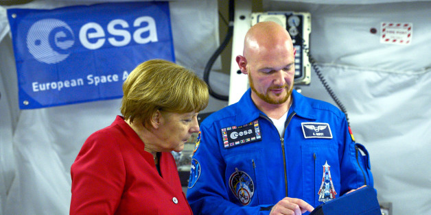 German Chancellor Angela Merkel (L) speaks with German astronaut Alexander Gerst in the Columbus Module as she visits the European Astronaut Centre (EAC), western Germany on May 18, 2016. REUTERS/ Sascha Schurmann/Pool