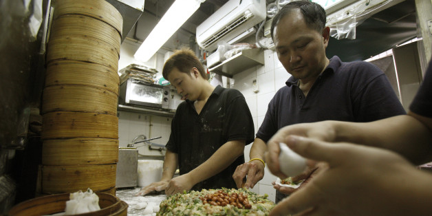 Workers prepare dim sum at the Michelin-starred Tim Ho Wan in Hong Kong's Mong Kok November 27, 2009. Michelin, the arbiter of the world's finest cuisine, awarded its coveted stars to several humble Hong Kong eateries which it said offer some of the world's best-value cuisine, although deluxe restaurants remained on top. To match Reuters Life! FOOD-MICHELIN/HONGKONG REUTERS/Tyrone Siu (CHINA SOCIETY FOOD)