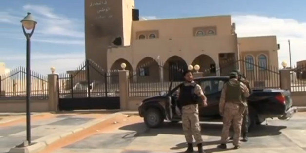 A still image from video released May 17, 2016 shows forces loyal to Libyan unity government outside the National Commercial bank after the recapture of Abu Grain, one of the main checkpoints south of the city of Misrata, Libya from Islamic State. MISRATA TV via REUTERS TV. ATTENTION EDITORS - THIS PICTURE WAS PROVIDED BY A THIRD PARTY. EDITORIAL USE ONLY. REUTERS IS UNABLE TO INDEPENDENTLY VERIFY THIS IMAGE. NO RESALES. NO ARCHIVE. FOR EDITORIAL USE ONLY