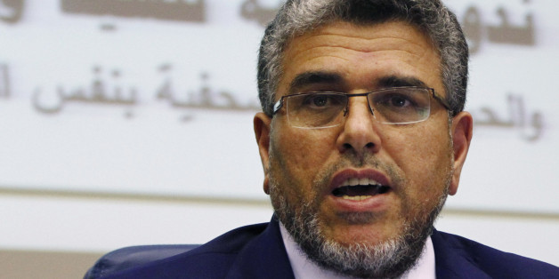 In this photo taken Thursday, Sept. 12, 2013, Moroccan Justice Minister Mustapha Ramid unveils a government plan to reform the country's justice system during a news conference in Rabat, Morocco. The judicial system has been a major sore point for Moroccans because of executive interference in political cases, bribing of judges, enormous backlogs and arbitrary verdicts. (AP Photo/Paul Schemm)