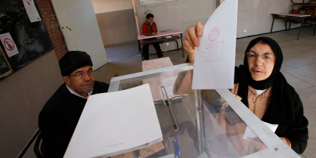 A voter casts her ballot at a polling station in Rabat November 25, 2011. Moroccans voted in a parliamentary election on Friday that could yield their most representative government ever after King Mohammed ceded some powers to prevent any tumultuous spillover of Arab Spring uprisings. REUTERS/Youssef Boudlal (MOROCCO - Tags: POLITICS ELECTIONS)