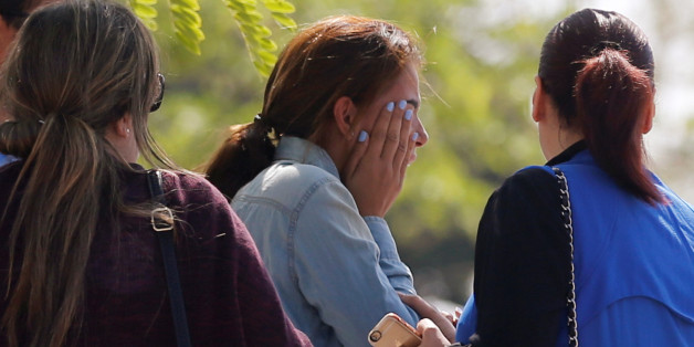 Unidentified relatives and friends of passengers who were flying in an EgyptAir plane that vanished from radar en route from Paris to Cairo react as they wait outside the Egyptair in-flight service building where relatives are being held at Cairo International Airport, Egypt May 19, 2016. REUTERS/Amr Abdallah Dalsh