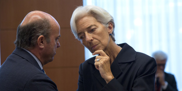 Managing Director of the International Monetary Fund Christine Lagarde, right, speaks with Spanish Economy Minister Luis de Guindos during a meeting of eurogroup finance ministers in Brussels on Saturday, June 27, 2015. Anxiety over Greece's future swelled on Saturday after Prime Minister Alexis Tsipras' call to have the people vote on a proposed bailout deal. (AP Photo/Virginia Mayo)