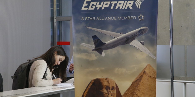 A reporter writes at the EgyptAir counter at Charles de Gaulle Airport outside of Paris, Thursday, May 19, 2016. An EgyptAir flight from Paris to Cairo with 66 passengers and crew on board crashed in the Mediterranean Sea early Thursday morning off the Greek island of Crete, Egyptian and Greek officials said. (AP Photo/Michel Euler)