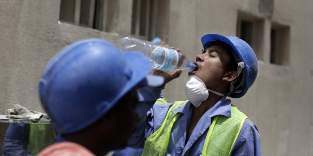 In this Sunday, May 3, 2015 file photo taken during a government organized media tour, Nischal Tamang from Nepal takes a break in his work, in Doha, Qatar. Tamang lives in a housing facility for laborers that has been cited by labor inspectors for substandard conditions. Human Rights Watch has released on Tuesday, Dec. 22, 2015 a set of guidelines it says construction companies working in the oil-rich Gulf Arab states should follow to ensure basic rights for migrant workers. Qatar in particular has come under intensified scrutiny over its labor practices since winning the rights to host the 2022 World Cup.(AP Photo/Maya Alleruzzo, File)