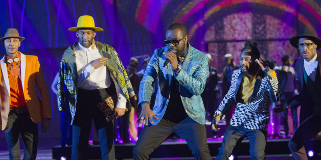 French rapper Gandhi Djuna aka Maitre Gims, center, performs on stage during the 31st Victoires de la Musique, the annual French music awards ceremony, on Friday, Feb. 12, 2016, in Paris, France.(AP Photo/Jacques Brinon)