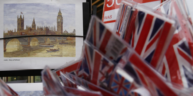 A poster of the houses of Parliament is displayed alongside Union flag souvenirs for sale in London, Britain, Thursday December 17, 2015. European Union leaders could clinch a deal with British Prime Minister David Cameron in February to prevent the bloc's second largest economy leaving, European Council President Donald Tusk said on Thursday. Cameron is seeking to renegotiate Britain's relationship with the bloc it joined in 1973 ahead of a referendum on membership to be held by the end of 20