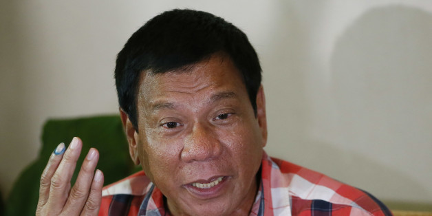 FILE- In this May 9, 2016, file photo, then front-running presidential candidate Mayor Rodrigo Duterte gestures during his second news conference after voting in a polling precinct at Daniel R. Aguinaldo National High School, Matina district, his hometown in Davao city in southern Philippines Monday, May 9, 2016. Presumptive Philippine President-elect Rodrigo Duterte said Monday he would offer Cabinet posts to communist rebels, move to amend the constitution to give more power to the provinces and reimpose the death penalty in some of his first policy pronouncements since winning last week's election based on an unofficial count. (AP Photo/Bullit Marquez, File)