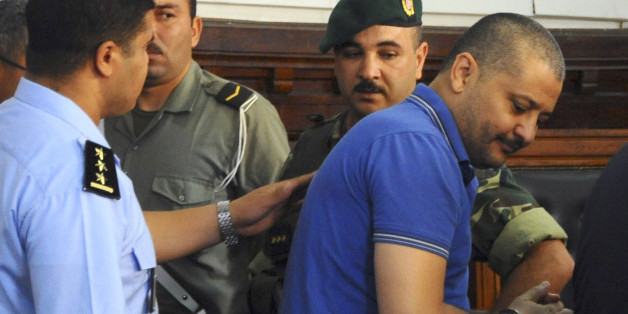 Imed Trabelsi, a nephew of ousted Tunisian President, Zile El Abidine Ben Ali, right, arrives before court for a trial hearing in Tunis, Tunisia, Tuesday, Aug. 2, 2011. A Tunisian court has granted defense lawyers' request to postpone the trial of 23 relatives and close collaborators of ousted Tunisian dictator Zine El Abidine Ben Ali. The defendants face charges including illegal possession of foreign currency, jewelry trafficking and attempted flight. If convicted, they could be sentenced to six months to five years in prison as well as hefty fines. (AP Photo/Hassene Dridi)