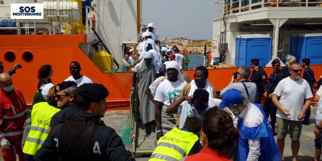 Migrants disembark from the SOS Mediterranee ship Aquarius at the Italian island of Lampedusa in this April 18, 2016.