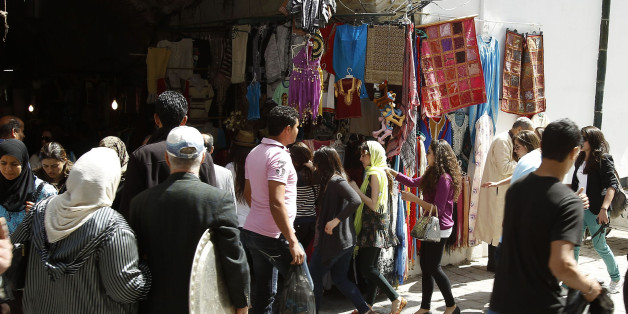 Tunisians walk at the Kasba souk in the old town of Tunisia April 2, 2012. At its factory on the outskirts of Tunis, U.S. company Eurocast is gearing up for expansion. The maker of parts for airplane engines plans to invest $2 million in its plant in late 2012, allowing it to process a new range of superalloys. Picture taken April 2, 2012. To match TUNISIA-INVESTMENT. REUTERS/Zoubeir Souissi (TUNISIA - Tags: SOCIETY BUSINESS)