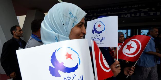 Supporters of Tunisia's Islamist Ennahdha Party wave the national and party flags on May 20, 2016 during the opening of Ennahdha's three-day congress in Tunis.Thousands of people attended the opening ceremony of the congress -- the first since 2012 -- held at a sports complex in Rades, south of the capital Tunis, amid heavy police security. / AFP / FETHI BELAID (Photo credit should read FETHI BELAID/AFP/Getty Images)