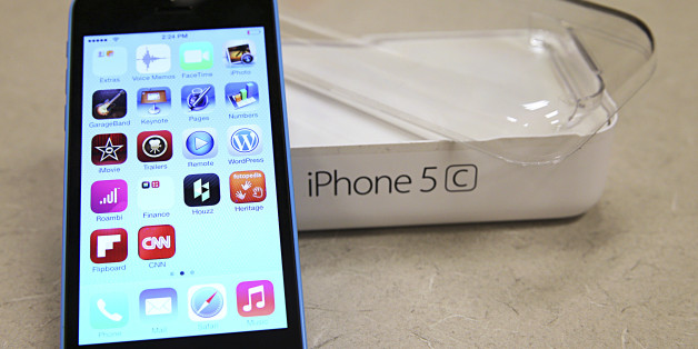 A new Apple iPhone 5C is on display at a Verizon store in Orem, Utah September 19, 2013. The iPhone 5C, which comes in blue, green, pink, yellow and white, starts in the U.S. at $99 with a contract and the pricier "5S" begins at $199 with a contract. Both models go on sale in several countries on September 20. REUTERS/George Frey (UNITED STATES - Tags: BUSINESS TELECOMS)