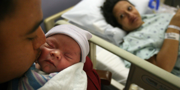 Lorenzo Ramirez, 28, kisses his newborn daughter Jennifer Ramirez, who is the first baby born on Galveston Island since Hurricane Ike, as mother Maria Hernandez, 38, looks on at the Labor & Delivery Unit at the University of Texas Medical Branch at Galveston, Monday, Oct. 13, 2008 in Galveston, Texas. Jennifer, born Monday morning and weighing in at 7 pounds, 8 ounces, was born on the first day of operations for UTMB's maternity unit since the storm. (AP Photo/Houston Chronicle, Mayra Beltran)