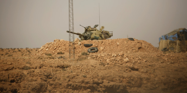 A Tunisian security forces tank is seen through a car window at Dhiba by the Tunisian and Libyan border crossing, Tunisia April 11, 2016. Tunisia's 2011 uprising created fertile ground for jihadist recruiters. Hundreds of Islamist militants were freed from prison as part of an amnesty for those detained under Ben Ali. Ultra-conservative salafists began to flex their muscle, seizing control of mosques and clashing with secularists. As Tunisia's politics have stabilised, the government has reasser