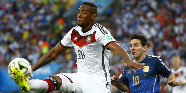 Germany's Jerome Boateng jumps to kick the ball in front of Argentina's Lionel Messi during their 2014 World Cup final at the Maracana stadium in Rio de Janeiro July 13, 2014. REUTERS/Kai Pfaffenbach (BRAZIL - Tags: SOCCER SPORT WORLD CUP TPX IMAGES OF THE DAY)
