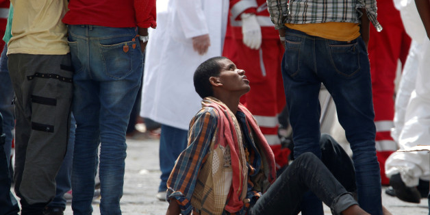 Migrants rest after disembarking in the Sicilian harbour of Catania, Italy, May 28, 2016. REUTERS/Antonio Parrinello