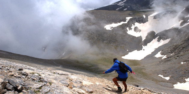A German hiker walks down a slope of Mount Olympus, at 2,500 meters (8,200 feet) in northern Greece, on Sunday, June 19, 2005. Olympus, Greece's tallest mountain at 2,917 meters (9,570 feet) was the mythological home of the ancient Greek gods. (AP Photo/Petros Giannakouris)